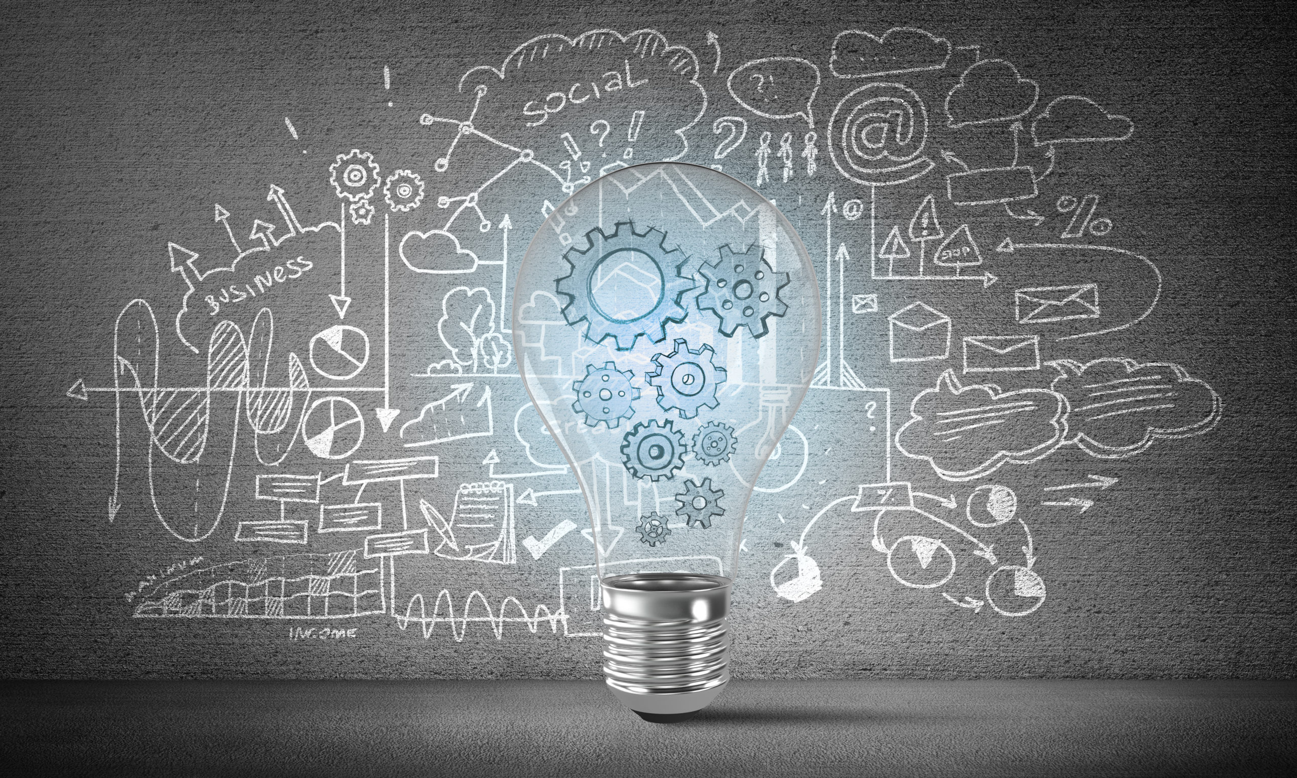 Drawing of light bulb in front of ideas board