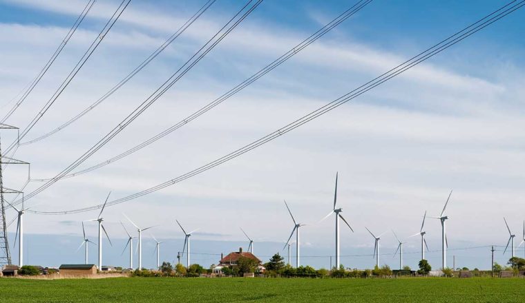 Image of electricity pylons and wind turbines