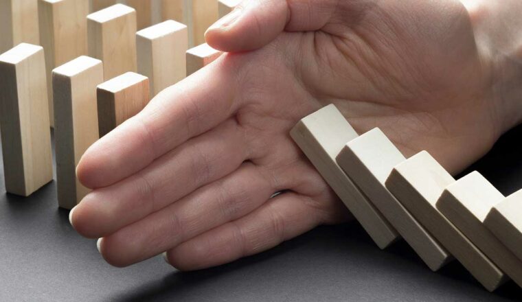 Hand holding back dominos