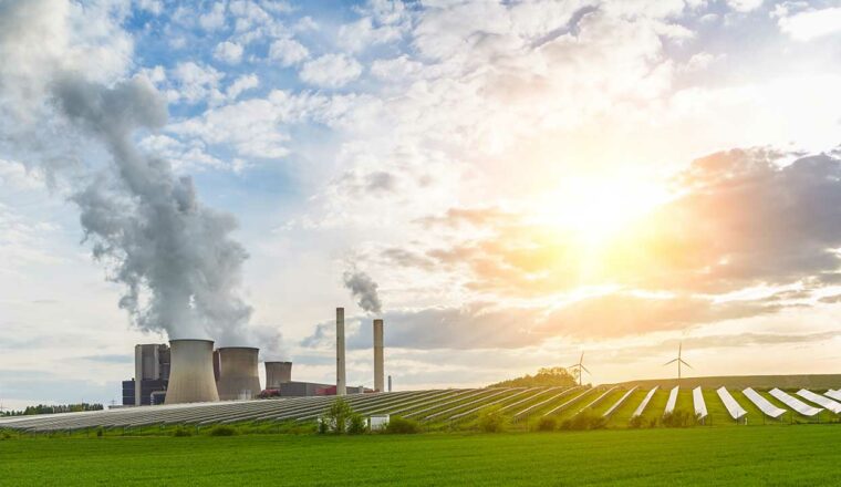 Photo of a factory, wind turbine and solar panels