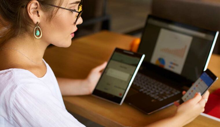 Woman working with multiple devices